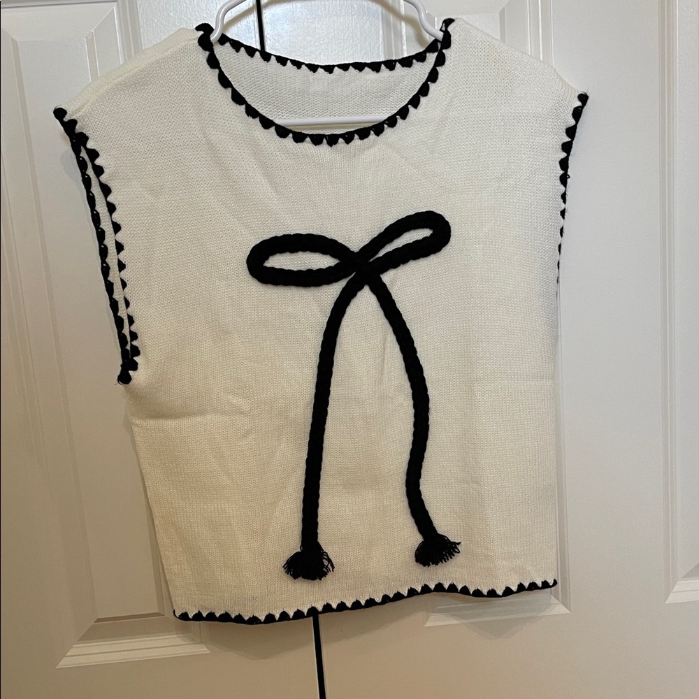 White Sleeveless Top with Black Bow Detail